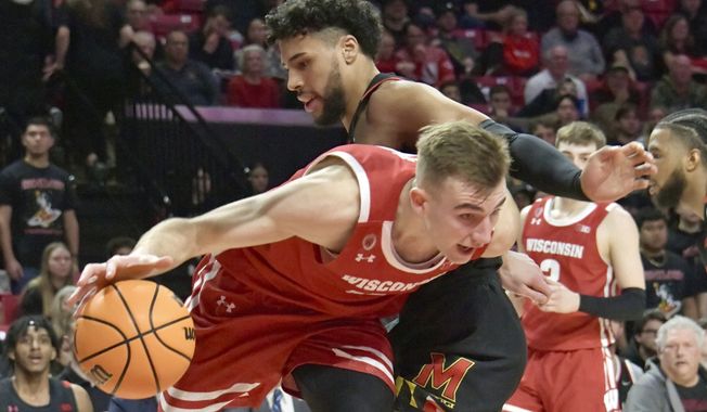 Wisconsin&#x27;s Tyler Wahl (5) barrels past Maryland&#x27;s Patrick Emilien (15) during the first half of an NCAA college basketball game, Wednesday, Jan. 25, 2023 in College Park, Md. (Amy Davis/The Baltimore Sun via AP)