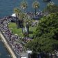 People line the foreshore to watch activities on Sydney Harbour during Australia Day celebration in Sydney, Thursday, Jan. 26, 2023. Australia marks the anniversary of British colonists settling modern day Sydney in 1788 while Indigenous protesters deride Australia Day as Invasion Day. (AP Photo/Rick Rycroft)