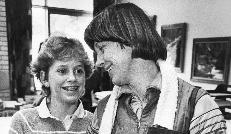 FILE - Kristin Preble, 13, and her mother Carol, get ready to leave the Ingomar Middle School in Franklin Park, Pa., Jan. 21, 1984. Kristin brought a briefcase with classified government documents to school as a show-and-tell project for her class. Her dad had found them in his Cleveland hotel room several years earlier and taken them home as a souvenir. Marked "Classified, Confidential, Executive" and "Property of the United States Government," the material from the Carter White House ended up in the hands of the Reagan campaign and, eventually, the schoolgirl. (AP Photo/Keith B. Srakocic, File)