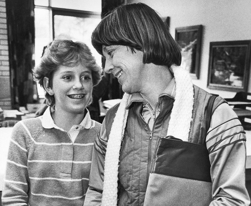 FILE - Kristin Preble, 13, and her mother Carol, get ready to leave the Ingomar Middle School in Franklin Park, Pa., Jan. 21, 1984. Kristin brought a briefcase with classified government documents to school as a show-and-tell project for her class. Her dad had found them in his Cleveland hotel room several years earlier and taken them home as a souvenir. Marked "Classified, Confidential, Executive" and "Property of the United States Government," the material from the Carter White House ended up in the hands of the Reagan campaign and, eventually, the schoolgirl. (AP Photo/Keith B. Srakocic, File)