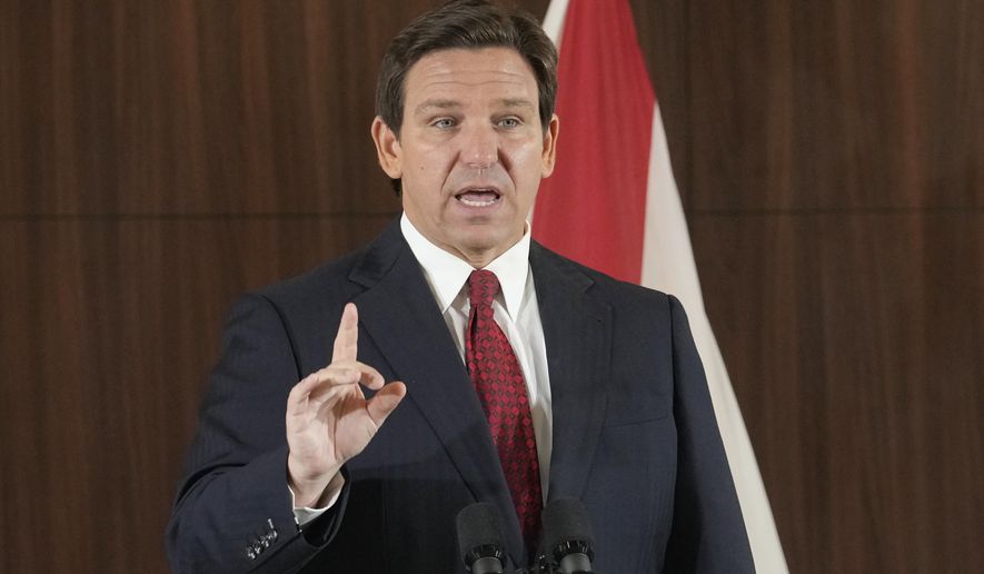 Governor Ron DeSantis listens to others during a news conference where he spoke of new law enforcement legislation that will be introduced during the upcoming session, Thursday, Jan. 26, 2023, in Miami. (AP Photo/Marta Lavandier)