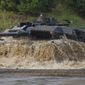 A Leopard 2A6 main battle tank drives through a pool of water during preparations for the &#39;Land Operations 2017&#39; information training exercise in Munster, Germany, Sept 25, 2017. The German government has confirmed it will provide Ukraine with Leopard 2 battle tanks and approve requests by other countries to do the same. Chancellor Olaf Scholz said Wednesday that Germany was &#39;acting in close coordination&#39; with its allies. (Philipp Schulze/dpa via AP, file)