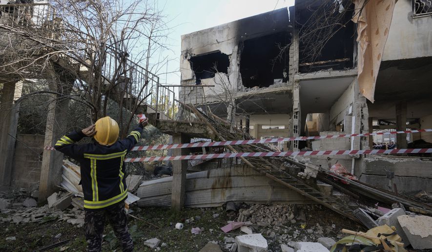 Palestinian rescuers inspect the site of a damaged building following an Israeli forces raid in the West Bank city of Jenin, Thursday, Jan. 26, 2023. Israeli forces killed at least nine Palestinians, including a 60-year-old woman, and wounded several others during a raid in the flashpoint area of the occupied West Bank, Palestinian health officials said, in one of the deadliest days of fighting in years. The Israeli military said it was conducting an operation to arrest militants when a gun battle erupted. (AP Photo/Majdi Mohammed)