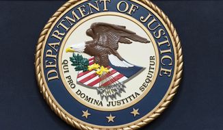 The Department of Justice seal is seen before a news conference to announce an international ransomware enforcement action at the Department of Justice in Washington, Thursday, Jan. 26, 2023. The FBI has seized the website of a prolific ransomware gang that has heavily targeted hospitals and other healthcare providers. (AP Photo/Jose Luis Magana)