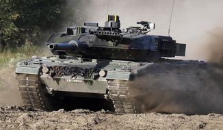 A Leopard 2 tank is pictured during a demonstration event held for the media by the German Bundeswehr in Munster near Hannover, Germany, Wednesday, Sept. 28, 2011. The German government has confirmed it will provide Ukraine with Leopard 2 battle tanks and approve requests by other countries to do the same. Chancellor Olaf Scholz said Wednesday that Germany was “acting in close coordination” with its allies. (AP Photo/Michael Sohn) **FILE**