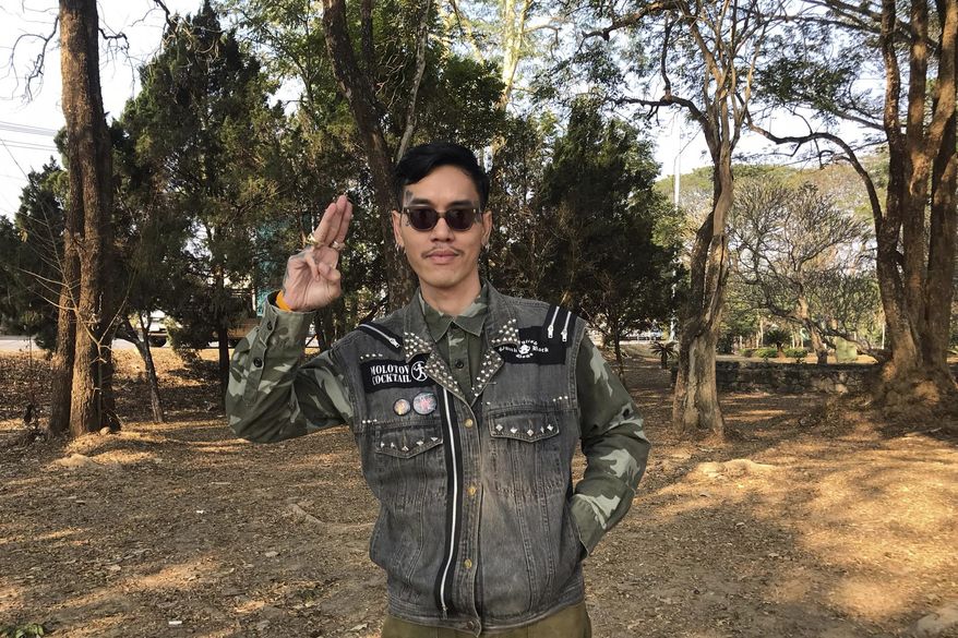 Political activist Mongkhon Thirakot flashes the pro-democracy gesture of a three-finger salute ahead of going to a court in Thailand&#x27;s northern province of Chiang Rai, Thailand, Thursday Jan. 26, 2023. Mongkhon has been sentenced to 28 years in prison for the crime of insulting the king in posts he uploaded to Facebook. (Thai Lawyers for Human Rights via AP)