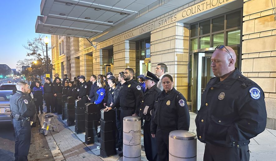 U.S. Capitol police officers stand outside the federal courthouse in Washington, Friday, Jan. 27, 2023, after attending the sentencing hearing for Julian Khater and co-defendant, George Tanio. Both men joined the mob that stormed the Capitol on Jan. 6, 2021. (AP Photo/Michael Kunzelman)
