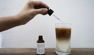An employee adds drops of water-soluble CBD, or cannabidiol, an essential component of medical marijuana, into a coffee glass at the Found Cafe in Hong Kong on Sept. 13, 2020.Hong Kong will ban cannabidiol or CBD from the beginning of next month, authorities announced Friday, Jan. 27, 2023. (AP Photo/Vincent Yu, File)