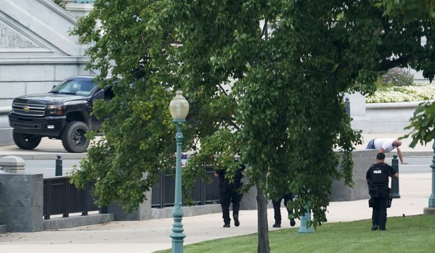 A man is apprehended after being in a pickup truck parked on the sidewalk in front of the Library of Congress&#x27; Thomas Jefferson Building, as seen from a window of the U.S. Capitol, Aug. 19, 2021, in Washington. A man who caused evacuations and an hourslong standoff with police on Capitol Hill when he claimed he had a bomb in his pickup truck outside the Library of Congress pleaded guilty on Friday, Jan. 27, 2023, to a charge of threatening to use an explosive. Floyd Ray Roseberry faces up to 10 years behind bars and is scheduled to be sentenced in June. (AP Photo/Alex Brandon, File)