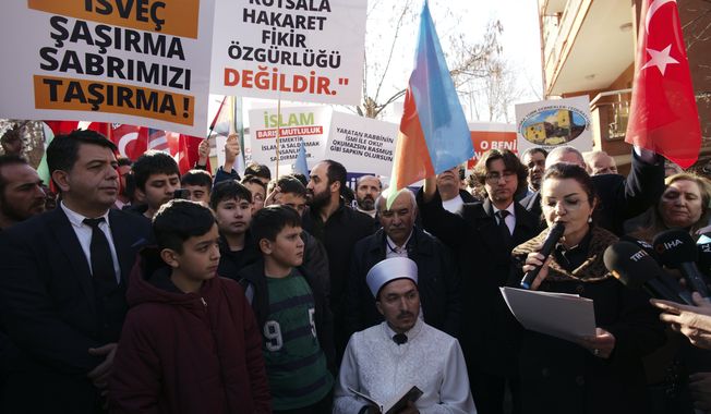An Imam recites from the Quran, Islam&#x27;s holy book, during a demonstration outside the Swedish embassy in Ankara, Turkey, Tuesday, Jan. 24, 2023. Outrage over a Quran-burning by a Danish-Swedish anti-Islam politician in Stockholm on Saturday caused protests in Turkey, reflecting tensions between the two countries. (AP Photo/Burhan Ozbilici)