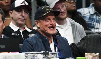 Actor Woody Harrelson laughs as he watches the second half of an NBA basketball game between Los Angeles Clippers and the Atlanta Hawks Saturday, Jan. 28, 2023, in Atlanta. (AP Photo/John Bazemore)