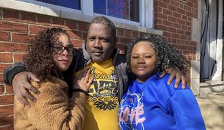 McKynzi Douglas, right, stands with her parents, John and Janay Douglas, outside their home on Thursday, Jan. 26, 2023, in St. Louis, Mo. McKynzi and other students of Central Visual and Performing Arts High School in St. Louis recently returned to school for the first time since fleeing from a shooting last October that killed two and wounded seven. (AP Photo/Jim Salter)