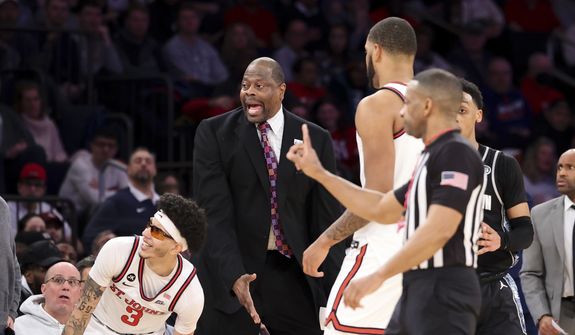 Georgetown head coach Patrick Ewing, center, reacts after a call along with St. John&#39;s guard Andre Curbelo (3) during the second half of an NCAA college basketball game Sunday, Jan. 29, 2023, in New York. (AP Photo/Jessie Alcheh)