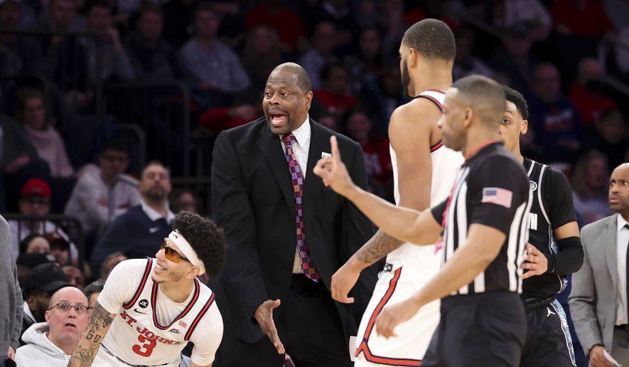 Georgetown head coach Patrick Ewing, center, reacts after a call along with St. John&#x27;s guard Andre Curbelo (3) during the second half of an NCAA college basketball game Sunday, Jan. 29, 2023, in New York. (AP Photo/Jessie Alcheh)