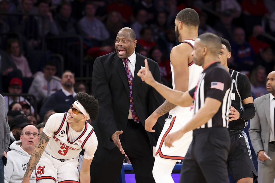 Georgetown head coach Patrick Ewing, center, reacts after a call along with St. John&#x27;s guard Andre Curbelo (3) during the second half of an NCAA college basketball game Sunday, Jan. 29, 2023, in New York. (AP Photo/Jessie Alcheh)