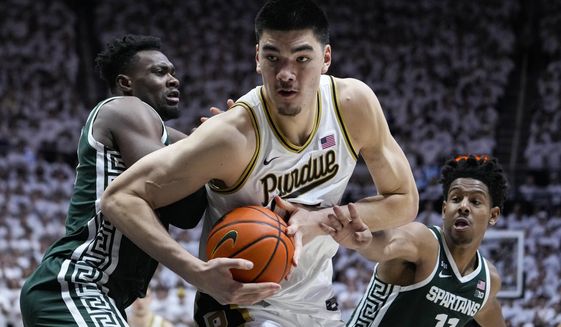 Purdue center Zach Edey (15) moves to the basket between Michigan State center Mady Sissoko (22) and guard A.J. Hoggard (11)during the second half of an NCAA college basketball game in West Lafayette, Ind., Sunday, Jan. 29, 2023. Purdue defeated Michigan State 77-61. (AP Photo/Michael Conroy) **FILE**