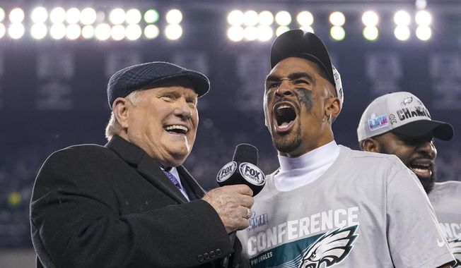 Philadelphia Eagles quarterback Jalen Hurts, center, reacts while speaking toTerry Bradshaw, left, after the NFC Championship NFL football game between the Philadelphia Eagles and the San Francisco 49ers on Sunday, Jan. 29, 2023, in Philadelphia. The Eagles won 31-7. (AP Photo/Matt Slocum) **FILE**
