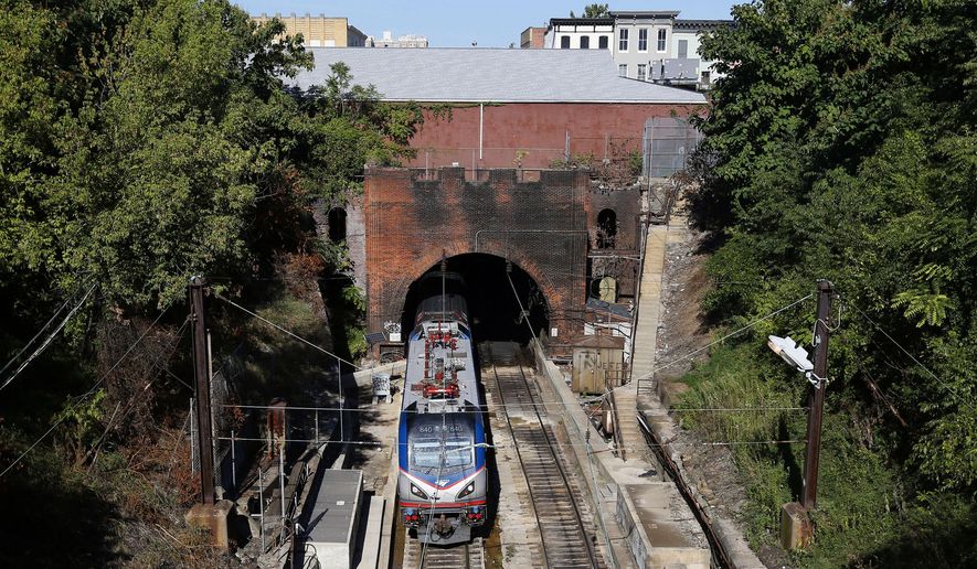 An Amtrak train emerges from the Baltimore and Potomac Tunnel in Baltimore, Sept. 15, 2015. The tunnel is finally slated to be replaced with help from the $1 trillion bipartisan infrastructure legislation championed by Biden, and he plans to visit on Monday to talk about the massive investment. (AP Photo/Patrick Semansky, File)