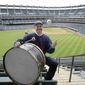 In this April 27, 2011, photo, Cleveland Indians fan John Adams poses in his usual centerfield bleacher seat with his ever-present bass drum before a baseball game between the Indians and the Kansas City Royals in Cleveland. Adams, who pounded a drum while sitting in Cleveland&#x27;s outfield bleachers during baseball games for five decades, has died. He was 71. The Guardians announced his passing on Monday, Jan. 30, 2023. (AP Photo/Amy Sancetta) **FILE**