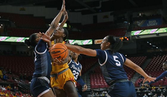 Penn State&#x27;s Leilani Kapinus, right, blocks a shot by Maryland&#x27;s Diamond Miller, center front, in the first quarter of an NCAA college basketball game in College Park, Md., Monday, Jan. 30, 2023. (Kenneth K. Lam/The Baltimore Sun via AP)