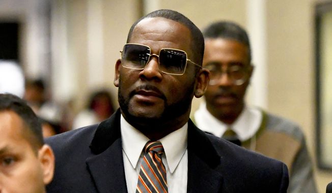 Musician R. Kelly, center, leaves the Daley Center after a hearing in his child support case on May 8, 2019, in Chicago. A Chicago prosecutor said Monday, Jan. 30, 2023, that she&#x27;s dropping sex-abuse charges against singer R. Kelly, following federal convictions in two courts that ensure the disgraced R&amp;B star will be locked up for decades.(AP Photo/Matt Marton, File)