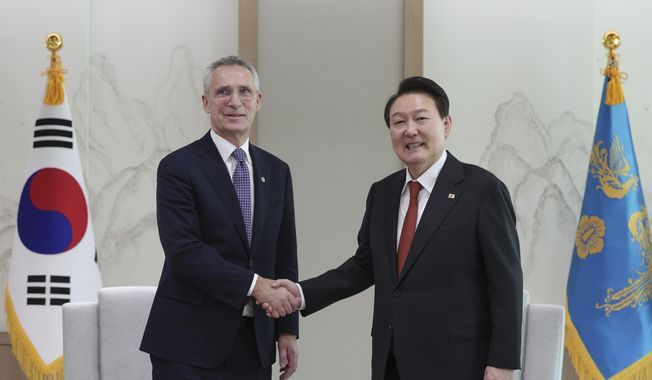 South Korean President Yoon Suk Yeol, right, shakes hands with NATO Secretary-General Jens Stoltenberg during a meeting at the presidential office in Seoul, South Korea, Monday, Jan. 30, 2023. (South Korea Presidential Office/Yonhap via AP)
