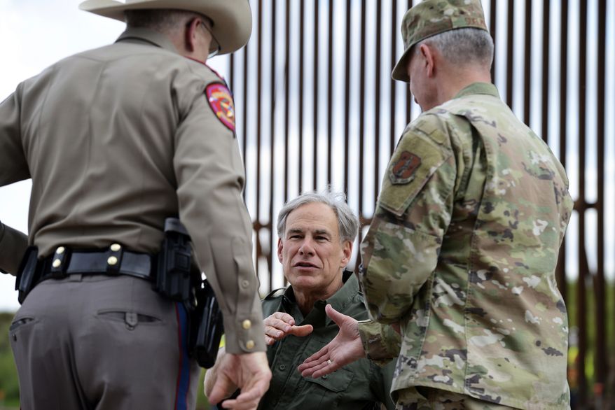 Texas Gov. Greg Abbott visits San Benito, Texas, near a U.S. border fence construction site Monday, Jan. 30, 2023, as he prepares to shake the hand of Adjutant Gen. of the Texas Military Department Major Gen. Thomas M. Suelzer during a press conference on the state&#x27;s efforts to better secure the border region. (Miguel Roberts/The Brownsville Herald via AP) ** FILE **
