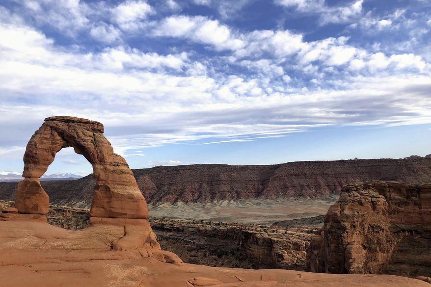Delicate Arch is seen at Arches National Park on April 25, 2021, near Moab, Utah. The United States will pay more than $10 million in damages over the death of Esther Nakajjigo, a prominent Ugandan human rights activist killed in Arches National Park in 2020. Nakajjigo was decapitated after wind swung an untethered metal gate into her car, killing her immediately as her husband sat in the seat next to her. (AP Photo/Lindsay Whitehurst, File)