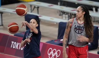 United States&#x27; Diana Taurasi, left, and Brittney Griner tale part in a women&#x27;s basketball practice at the 2020 Summer Olympics, July 24, 2021, in Saitama, Japan. Taurasi’s USA Basketball career isn’t done just yet. The five-time Olympic gold medalist is part of the national team training camp in Minnesota next month. While Taurasi will be at the camp, Brittney Griner won’t. She is still part of the pool that the 2024 Olympic team will be chosen from. (AP Photo/Eric Gay, file)