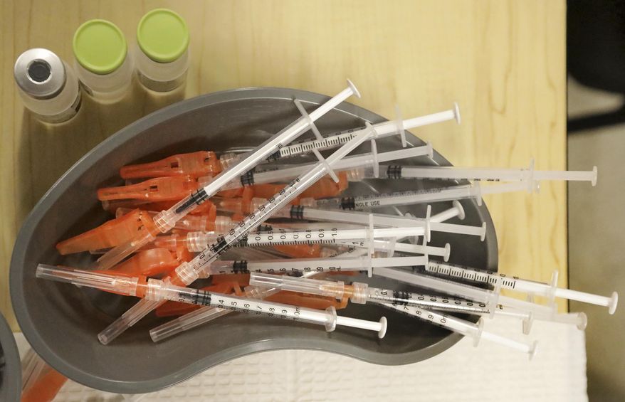 Pre-loaded syringes with COVID-19 vaccine are ready as medical staff vaccinate students at KIPP Believe Charter School in New Orleans, Jan. 25, 2022. (AP Photo/Ted Jackson, File)