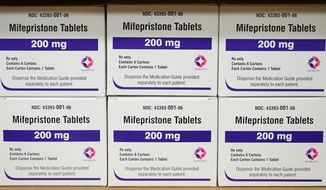 FILE - Boxes of the drug mifepristone sit on a shelf at the West Alabama Women&#x27;s Center in Tuscaloosa, Ala., on March 16, 2022. Attorney generals in 20 conservative-led states warned CVS and Walgreens on Wednesday, Feb. 1, 2023, that they could face legal consequences if they sell abortion pills by mail in those states. (AP Photo/Allen G. Breed, File)