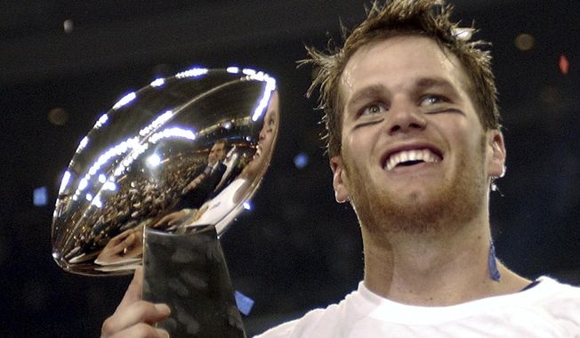 In this Feb. 1, 2004, file photo, New England Patriots quarterback Tom Brady holds the Vince Lombardi Trophy after the Patriots beat the Carolina Panthers 32-29 in Super Bowl 38 in Houston. Brady, who won a record seven Super Bowls for New England and Tampa, has announced his retirement, Wednesday, Feb. 1, 2023. (AP Photo/Dave Martin, File)