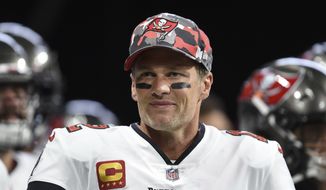 Tampa Bay Buccaneers quarterback Tom Brady (12) smiles during warmups before an NFL football game, Sunday, Jan. 8, 2023, in Atlanta.  Brady, who won a record seven Super Bowls for New England and Tampa, has announced his retirement, Wednesday, Feb. 1, 2023.   (AP Photo/Hakim Wright Sr., File)