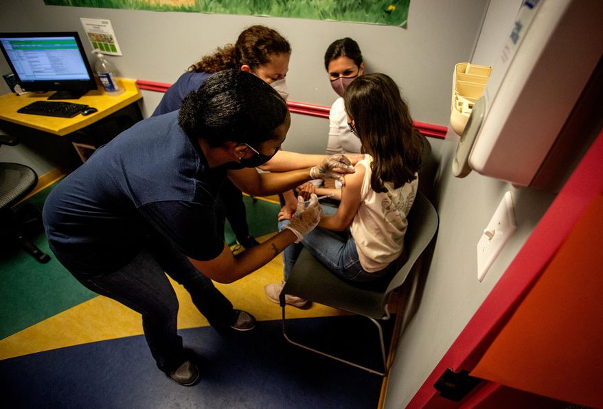 Middle school student Elise Robinson receives a coronavirus vaccination on May 12, 2021, in Decatur, Ga. A bill passed on Wednesday, Feb, 1 2023, by a Georgia Senate committee would ban public schools, local governments or state agencies from requiring people to get the COVID-19 vaccine before they could attend school or receive government services. (AP Photo/Ron Harris, File)