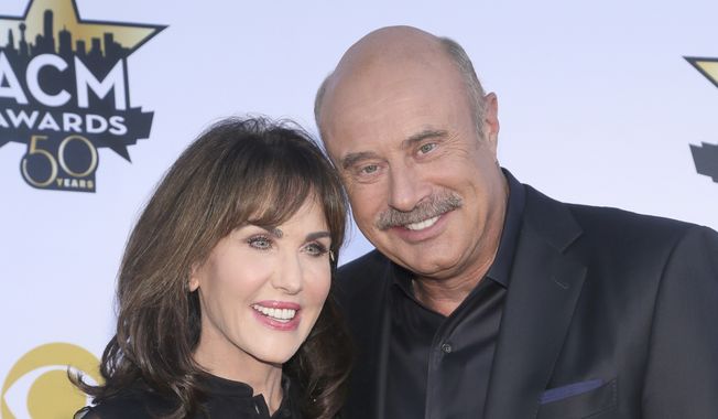 Robin McGraw, left, and Dr. Phil McGraw arrive at the 50th annual Academy of Country Music Awards at AT&amp;T Stadium on Sunday, April 19, 2015, in Arlington, Texas. McGraw says he&#x27;ll stop making new episodes of his daytime TV show after 21 years this spring. The Texas psychologist emerged from Oprah Winfrey&#x27;s TV tree, spinning off his frequent appearances there to start his own show in 2002. (Photo by Jack Plunkett/Invision/AP, File)