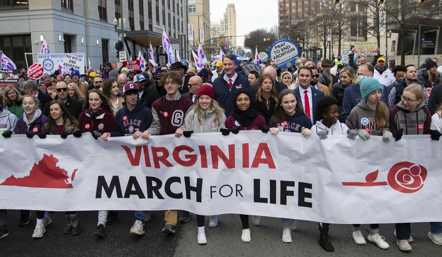 Virginia Gov. Glenn Youngkin marches with attendees at a &quot;March for Life&quot; event on Wednesday, Feb. 1, 2023, in Richmond, Va. (AP Photo/Mike Caudill)