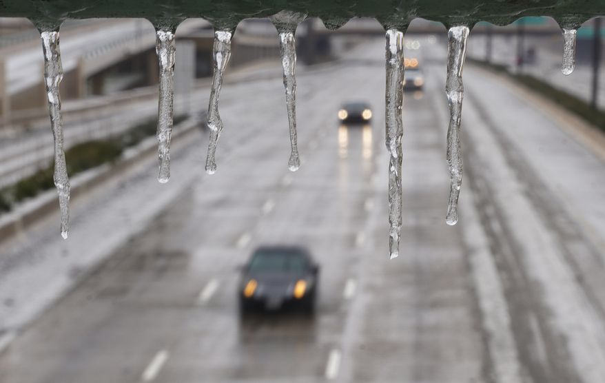 Cars drive down U.S.-75 despite the icy road conditions, Wednesday, Feb. 1, 2023, in Dallas. Dallas and other parts of North Texas are under a winter storm warning through Thursday. (Rebecca Slezak/The Dallas Morning News via AP)