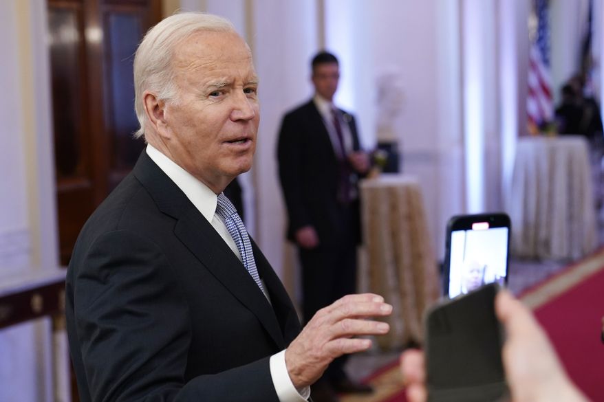 President Joe Biden talks with reporters after speaking in the East Room of the White House in Washington, Jan 20, 2023. A new poll shows that more U.S. adults disapprove than approve of the way President Joe Biden has handled the discovery of classified documents at his home and former office. Yet that seems to have had little impact on Biden's overall approval rating. (AP Photo/Susan Walsh, File)