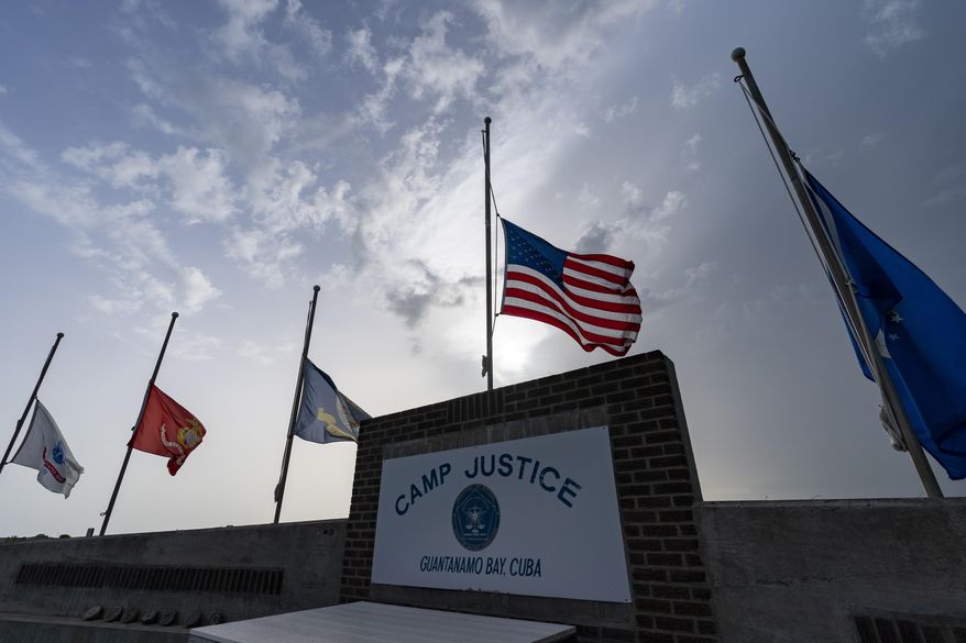 In this photo reviewed by U.S. military officials, flags fly at half-staff at Camp Justice, Aug. 29, 2021, in Guantanamo Bay Naval Base, Cuba. Majid Khan, the onetime courier for al-Qaida is a free man after serving more than 16 years at Guantanamo, and surviving torture at notorious CIA &quot;black sites.&quot; The Pentagon announced the release of Pakistan citizen Khan on Thursday, Feb. 2, 2023. Khan is now in Belize, after that nation reached agreement with the Biden administration to take him. (AP Photo/Alex Brandon, File)