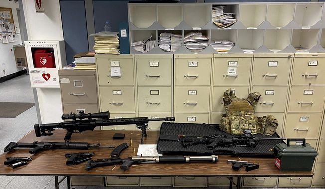 This photo provided by the Los Angeles Police Department shows guns and ammunition that were found in an L.A. apartment. A man who reportedly made violent threats was arrested and investigators found a cache of guns and ammunition in his Hollywood high-rise apartment, where several rifles were pointed at a nearby park, police said Wednesday, Feb. 1, 2023. (Los Angeles Police Department via AP)