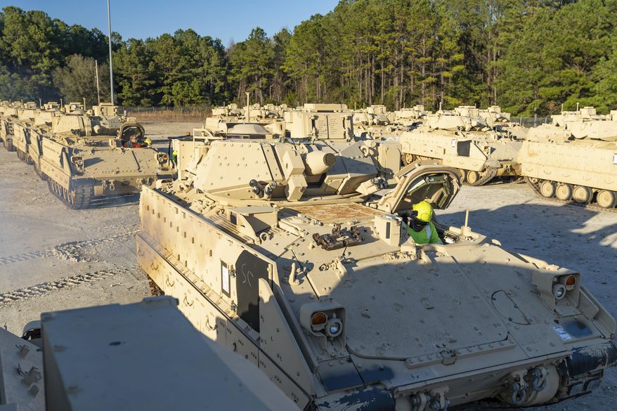 In this image provided by U.S. Transportation Command, a stevedore sits in a Bradley Fighting Vehicle before loading it onto the ARC Wallenius Wilhemsen Jan. 25, 2023, at the Transportation Core Dock in North Charleston, S.C. After months of agonizing, the U.S has agreed to send longer-range bombs to Ukraine as it prepares to launch a spring offensive to retake territory Russia captured last year, U.S. officials said Thursday, confirming that the new weapons will have roughly double the range of any other offensive weapon provided by America. (Oz Suguitan/U.S. Transportation Command via AP) **FILE**