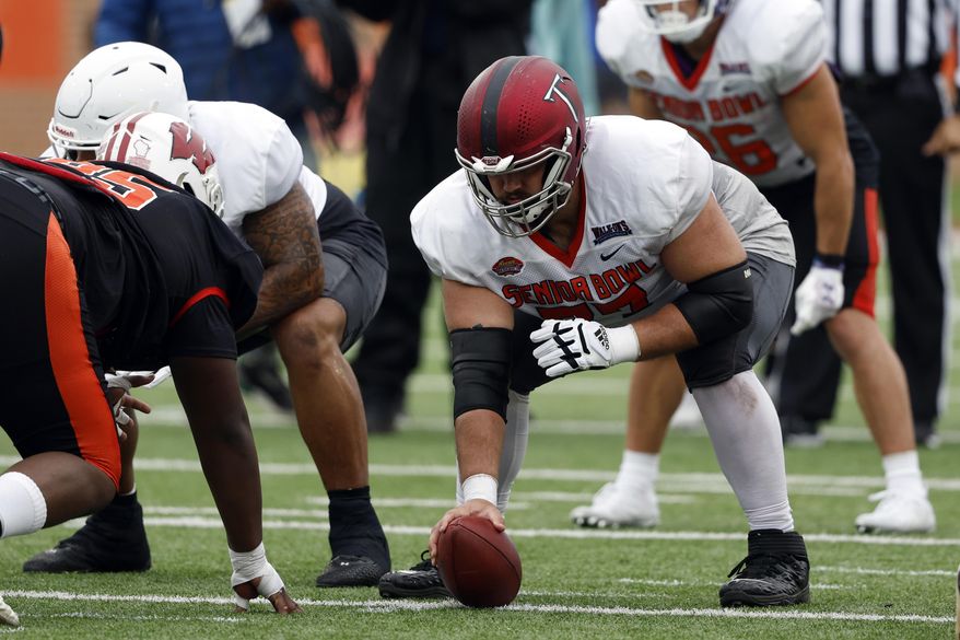 National offensive lineman Jake Andrews of Troy (77) runs drills during practice for the Senior Bowl NCAA college football game Thursday, Feb. 2, 2023, in Mobile, Ala.. (AP Photo/Butch Dill)