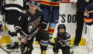 Washington Capitals&#39; Alex Ovechkin (8) and his son waits for the events to start during the NHL All Star Skills Showcase,Friday, Feb. 3, 2023, in Sunrise, Fla. (AP Photo/Marta Lavandier)