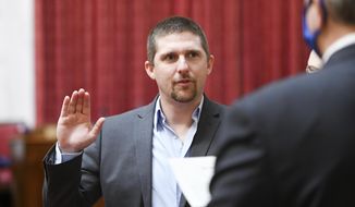 In this image provided by the West Virginia Legislative Photography, Derrick Evans is shown during his swearing-in ceremony to the West Virginia House of Delegates on Dec. 1, 2020, in Charleston, W.Va. Some Jan. 6 defendants who have expressed remorse in court after joining the pro-Trump mob that stormed the Capitol have later struck a different tone or sought to downplay the riot publicly. After pleading guilty to a felony charge in the riot, former West Virginia lawmaker Derrick Evans told a judge in June that he regrets his actions and takes full responsibility for them. He&#x27;s now running for Congress (Will Price, West Virginia Legislative Photography via AP)