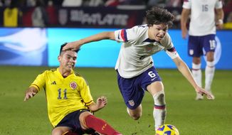 United States&#39; Paxten Aaronson, right, dribbles past Colombia&#39;s Daniel Ruiz during the second half of an international friendly soccer match Saturday, Jan. 28, 2023, in Carson, Calif. (AP Photo/Marcio Jose Sanchez)