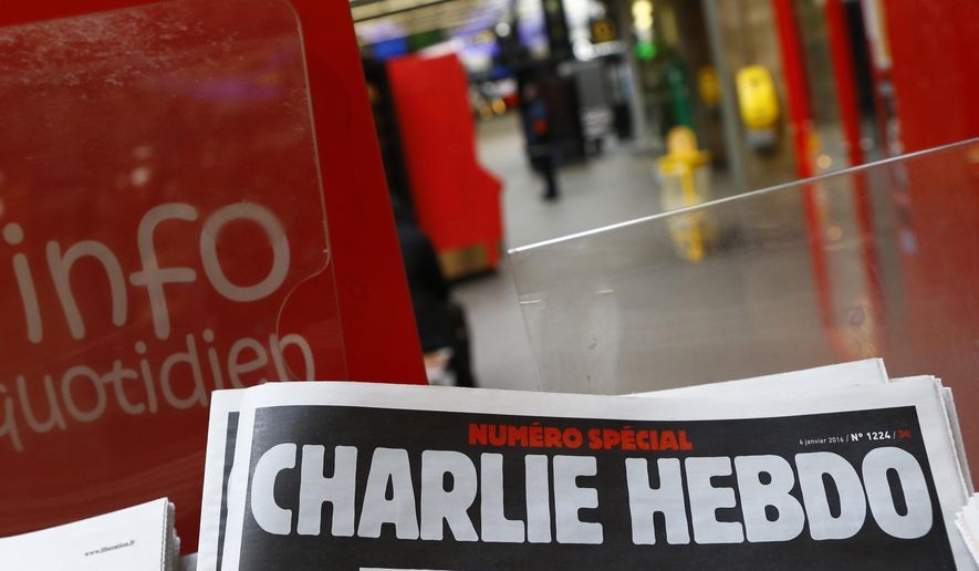 A special edition of the satirical newspaper Charlie Hebdo that marks one year after, &quot;1 an apres&quot; the attacks on it, on a newsstand Wednesday, Jan. 6, 2016 at a train station in Paris. After the French satirical magazine Charlie Hebdo&#x27;s launched a cartoon contest to mock Iran&#x27;s ruling cleric, a state-backed Iranian cyber unit struck back in early January with a hack-and-leak campaign intent on striking fear with the claimed pilfering of a big subscriber database, Microsoft security researchers say. (AP Photo/Francois Mori, File)