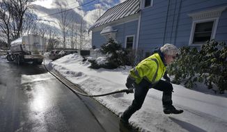 Peter Ellingwood delivers heating oil, Tuesday, Jan. 31, 2023, in Farmington, Maine. On Friday, the U.S. government issues the January jobs report. (AP Photo/Robert F. Bukaty)