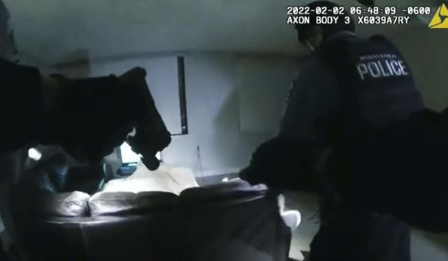 In this image taken from Minneapolis Police Department body camera video and released by the city of Minneapolis, Minneapolis police enter an apartment on Wednesday, Feb. 2, 2022, moments before shooting 22-year-old Amir Locke. The parents of Amir Locke, who was killed by a Minneapolis police officer when a SWAT team executed a no-knock search warrant one year ago, are suing the city and the officer, Friday, Feb. 3, 2023. (Minneapolis Police Department via AP)
