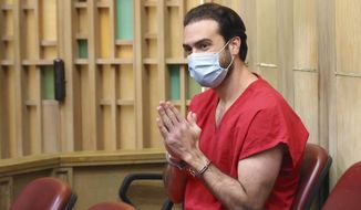 Pablo Lyle gestures toward family members as they appear in court at the Richard E. Gerstein Justice Building in Miami, on Monday, Dec. 12, 2022. Lyle, accused of fatally punching a driver during a road-rage incident in Miami in 2019, is expected to be sentenced for involuntary manslaughter. (Carl Juste/Miami Herald via AP, Pool, File)