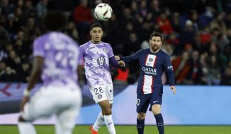 PSG&#x27;s Lionel Messi, right, eyes the ball next to Toulouse&#x27;s Fares Chaibi during the French League One soccer match between Paris Saint-Germain and Toulouse, at the Parc des Princes, in Paris, France, Saturday, Feb. 4, 2023. (AP Photo/Lewis Joly)